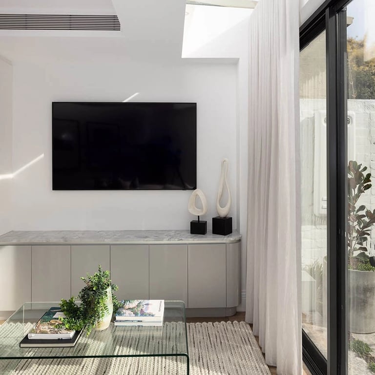 modern TV room in a restored Victorian terrace, featuring perimeter skylight glazing and modern furnishing in Surry Hills