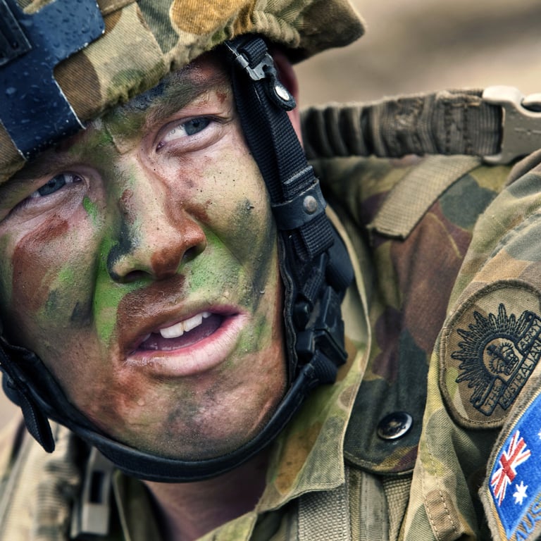 Close up of an Australian soldier in full camouflage uniform and face paint