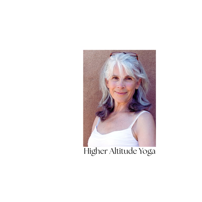 Portrait of a smiling senior yoga student at Higher Altitude Yoga against a warm wall.