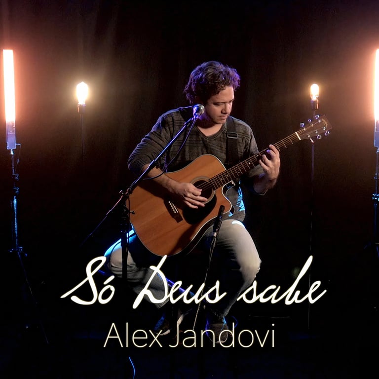 a man playing guitar and singing into a microphone