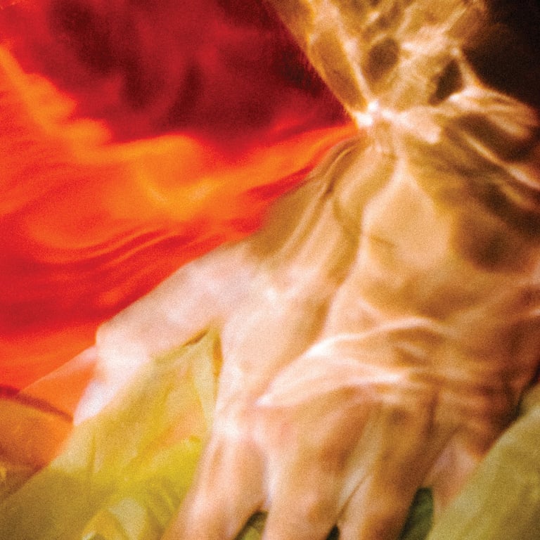 a person's hand holding a piece of art