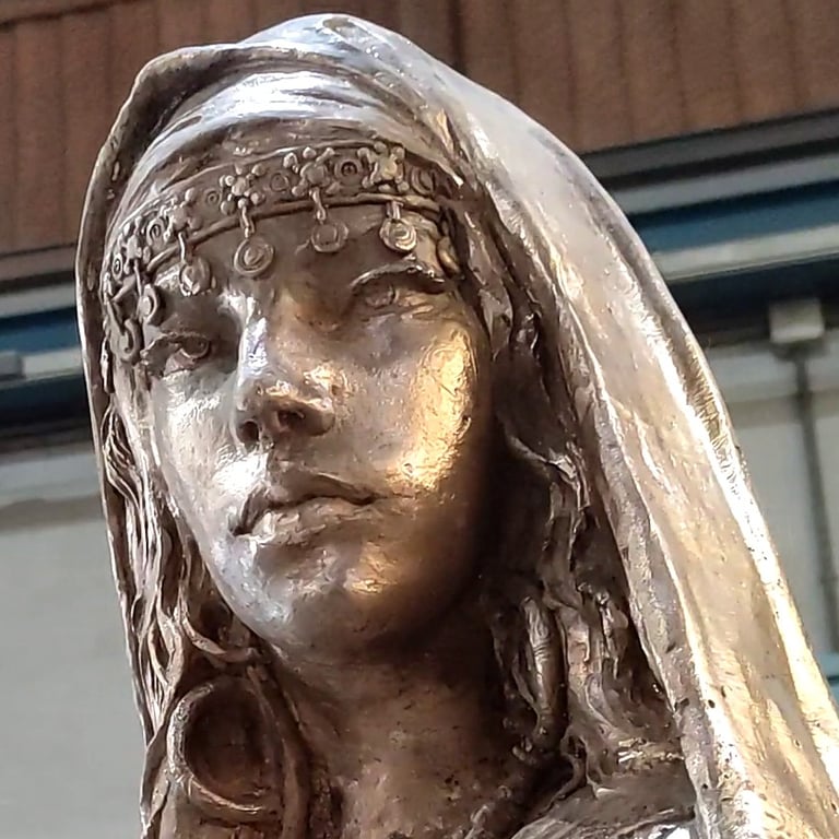 Bronze sculpture of a Muslim princess with traditional headdress and veil.