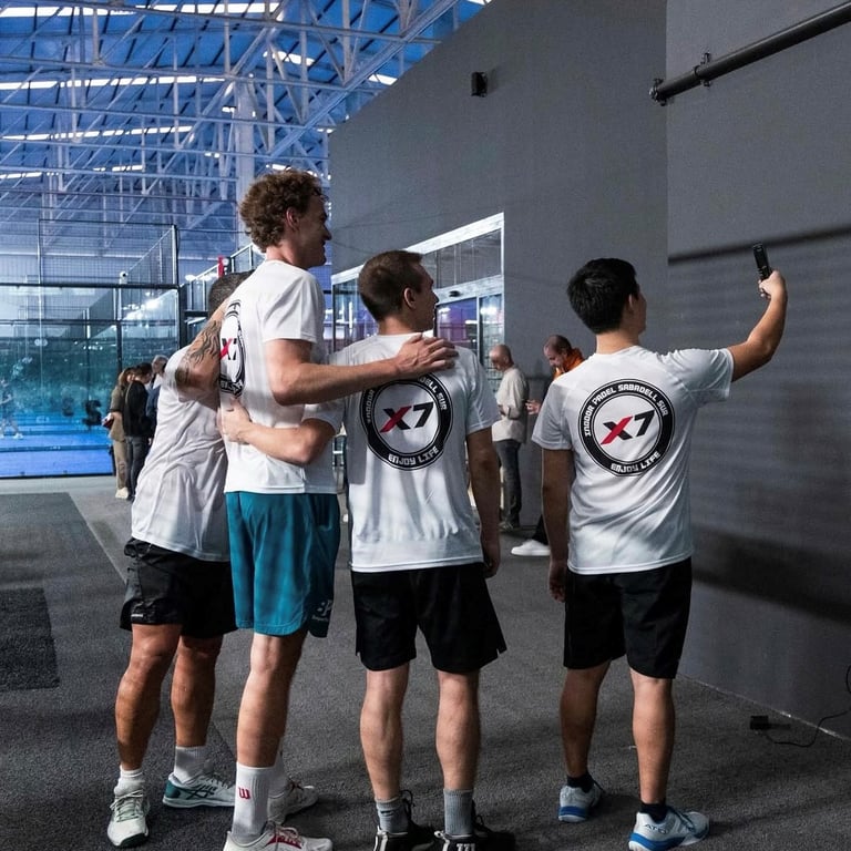Padel training camp students taking a selfie with their coach at Padel X7 Sabadell in Spain after a