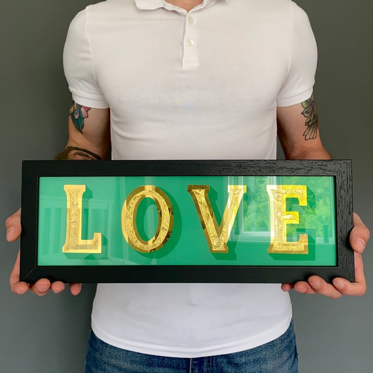 gold leaf sign, love, hand painted on glass with green background