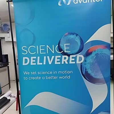 Large format printed banner with 'Science Delivered' text and Avanter branding.
