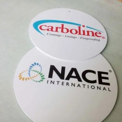 Two circular Sintra board signs with Carboline and NACE International logos.