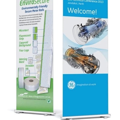 Two pull-up banners featuring EnvioSecure meter rolls and a technical conference welcome message.