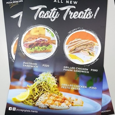 asty Treats menu poster on Sintra board featuring pastrami sandwich, grilled chicken panini sandwich