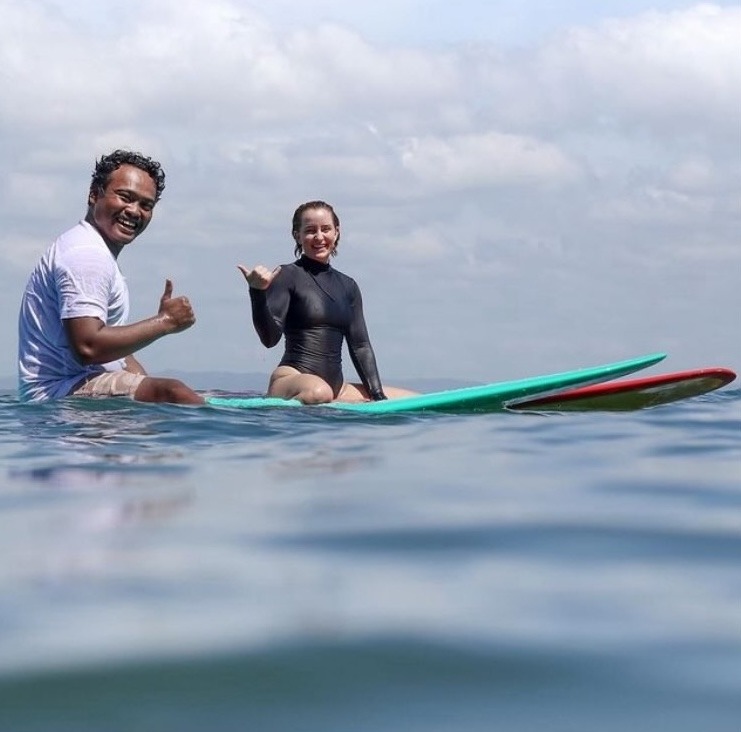 Ucup surfing with Laura in Batukaras