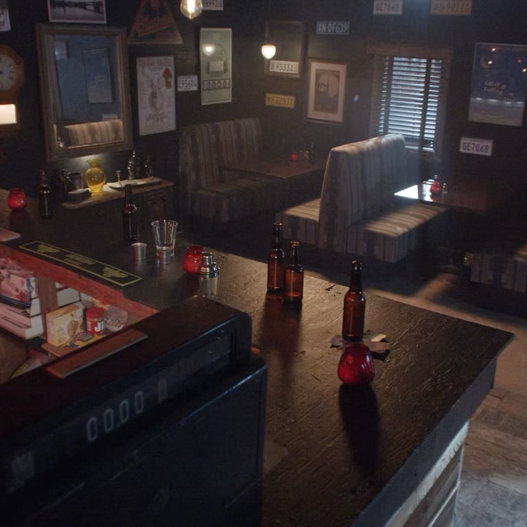 Bar room set at Grayfox Studios with counter, bottles, booths, and vintage wall decor