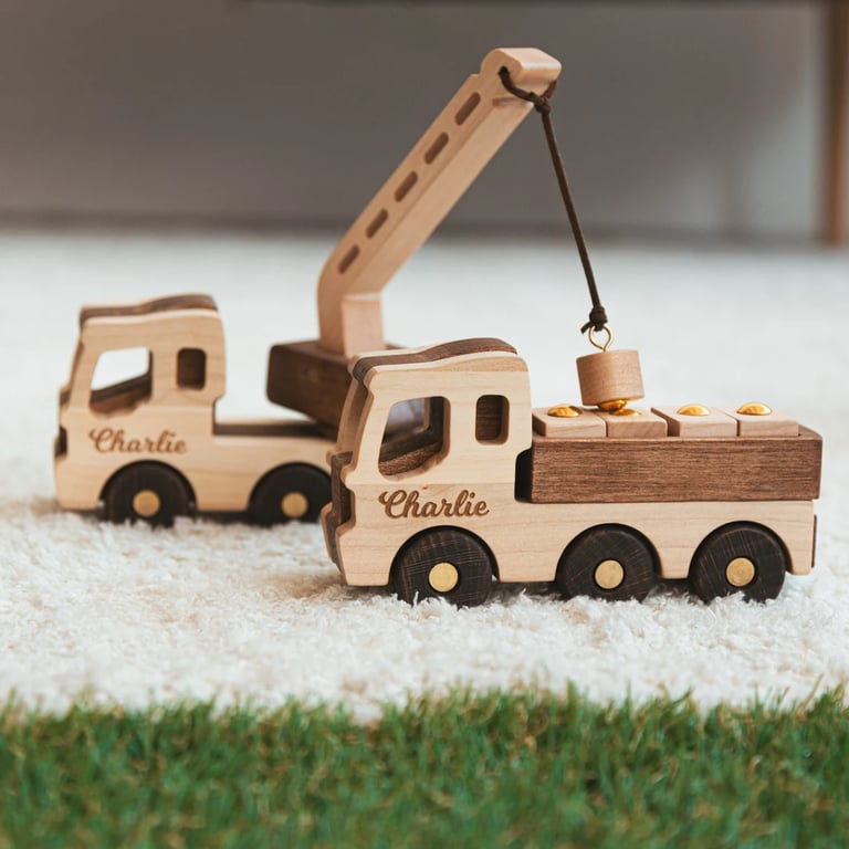 a wooden toy truck with a crane on it