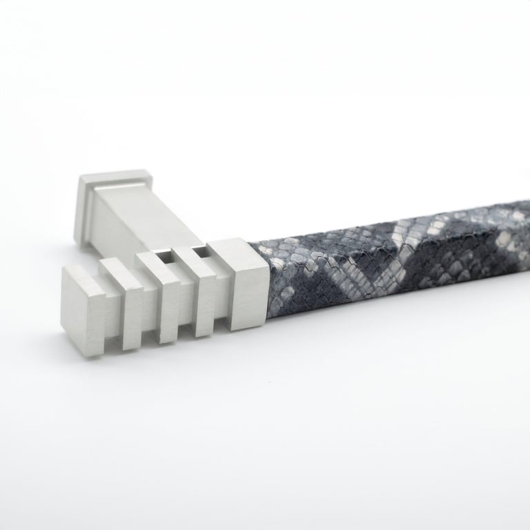 Photography case study featuring a cabinet pull with a leather wrap and silver metal finish.