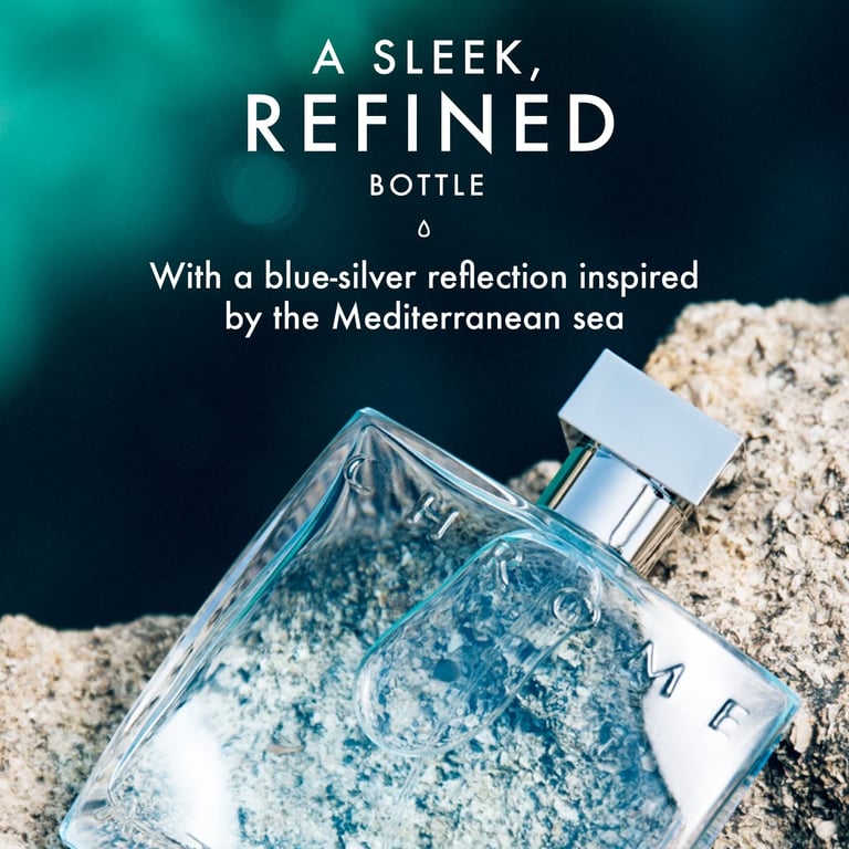 Sleek blue cologne bottle with silver reflection on a rock, inspired by the Mediterranean sea.