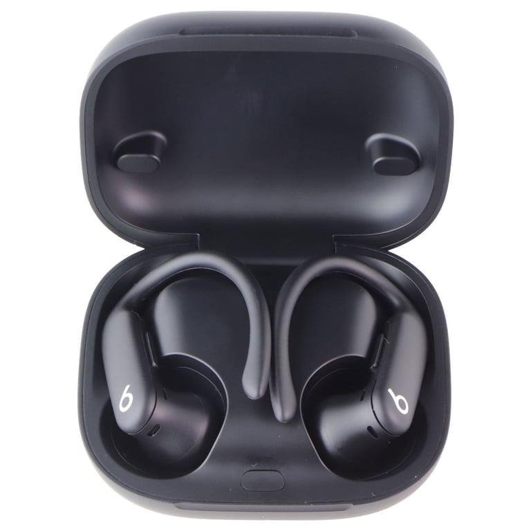 Black Powerbeats Pro wireless earbuds sitting inside their open charging case on a white background.