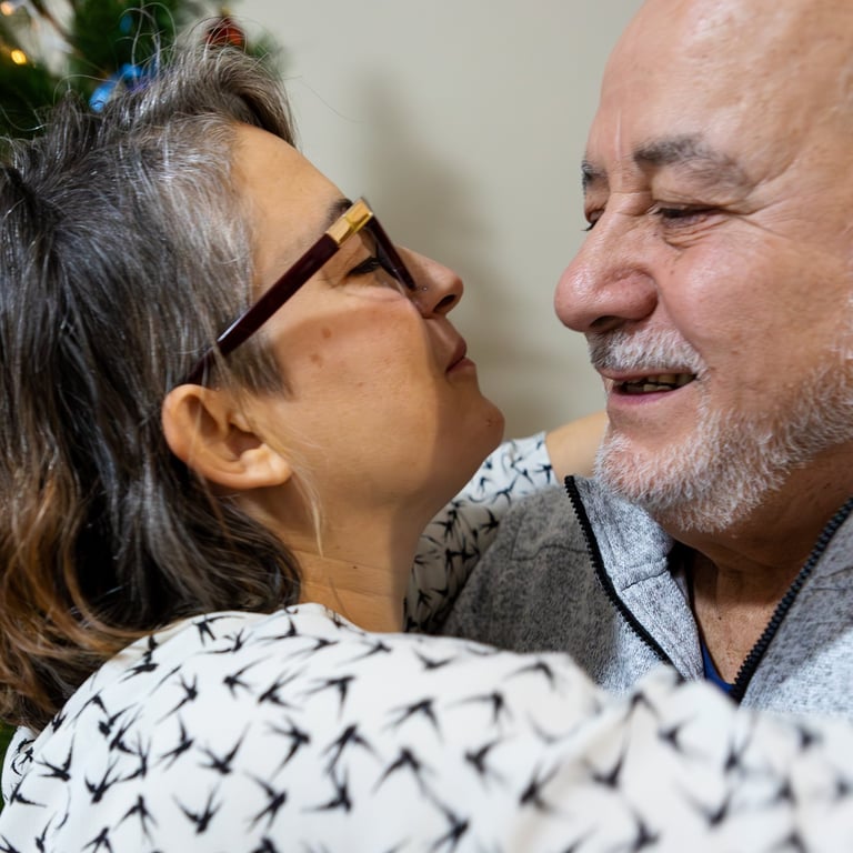 Smiling dad and daughter sharing an affectionate embrace during holiday celebrations at home.