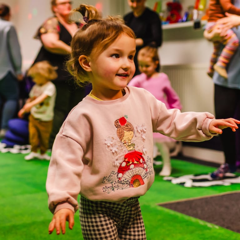 A young girl stood dancing in class for mixed moo.