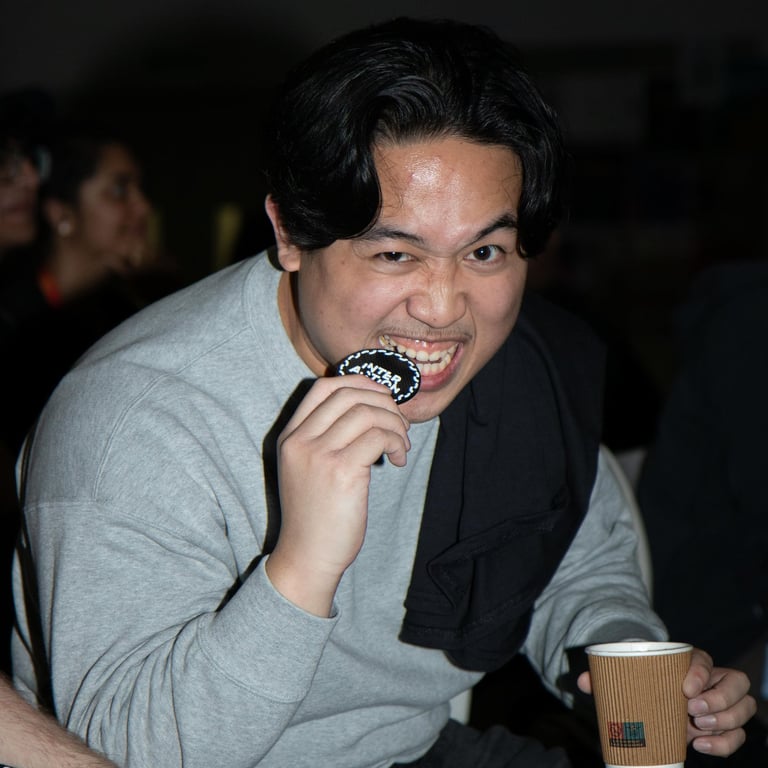 Candid event portrait of a guest enjoying food at an indoor event