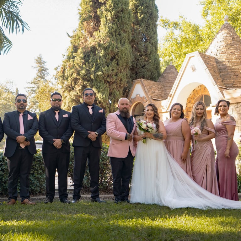 Visalia wedding photographer capturing a bridal party in pink and navy at an outdoor venue.