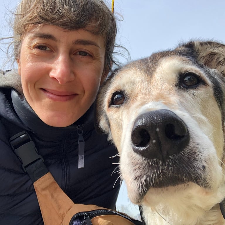 a close up selfie of lisa cinar and her senior dog pancake