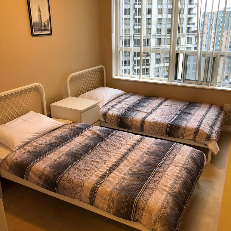 Modern bedroom with queen bed in Mississauga short-term rental