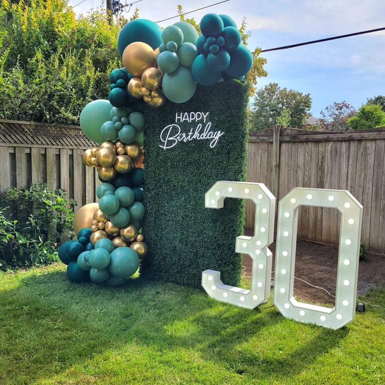30th marquee with green & gold balloons