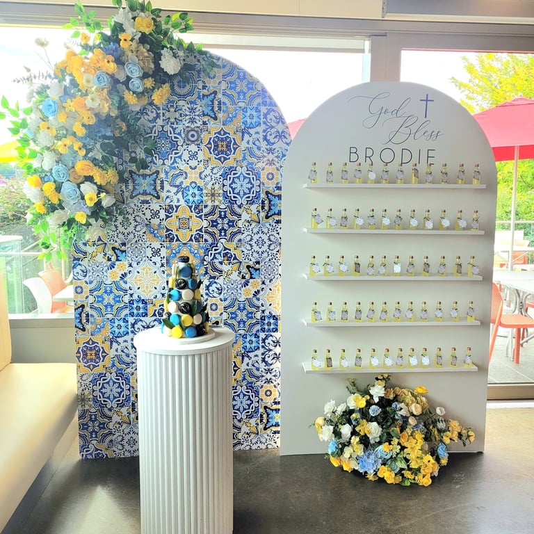 a amalfi backdrop of favor bottles and flowers