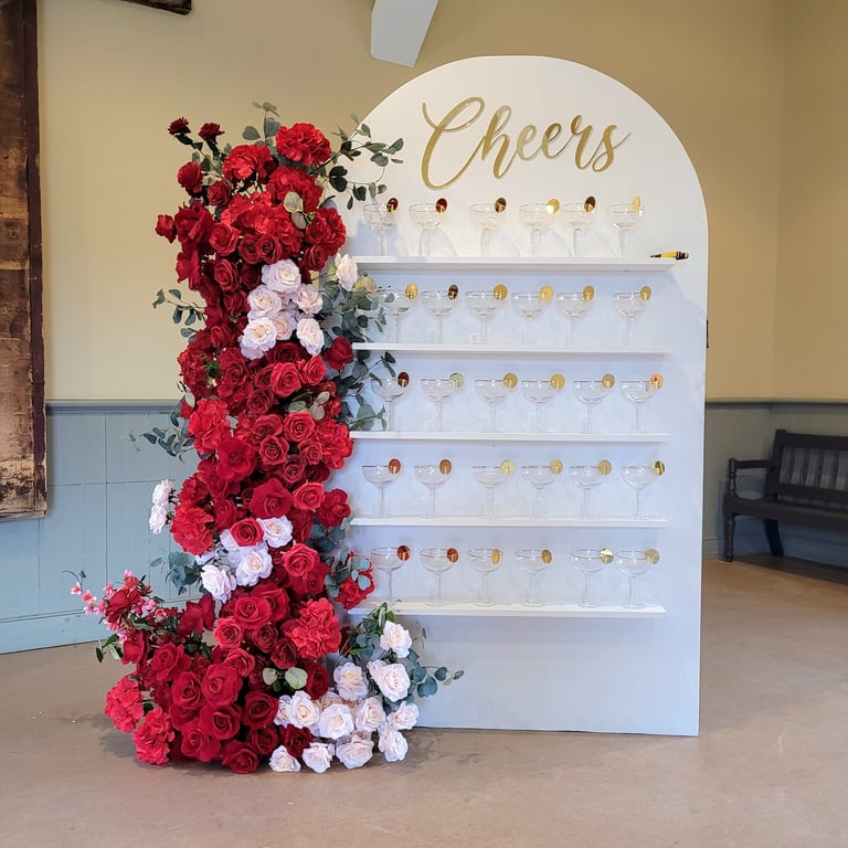 7ft x 4ft white champagne wall/treat wall display of red flowers mixed with blush pink roses