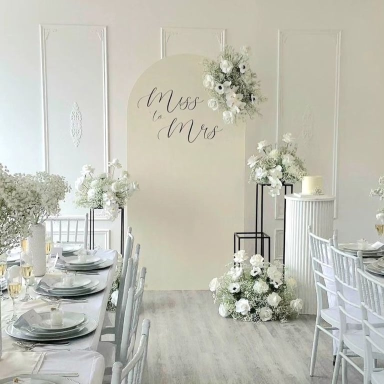 Bridal shower in an off white theme with 5 floral arrangements on black stands