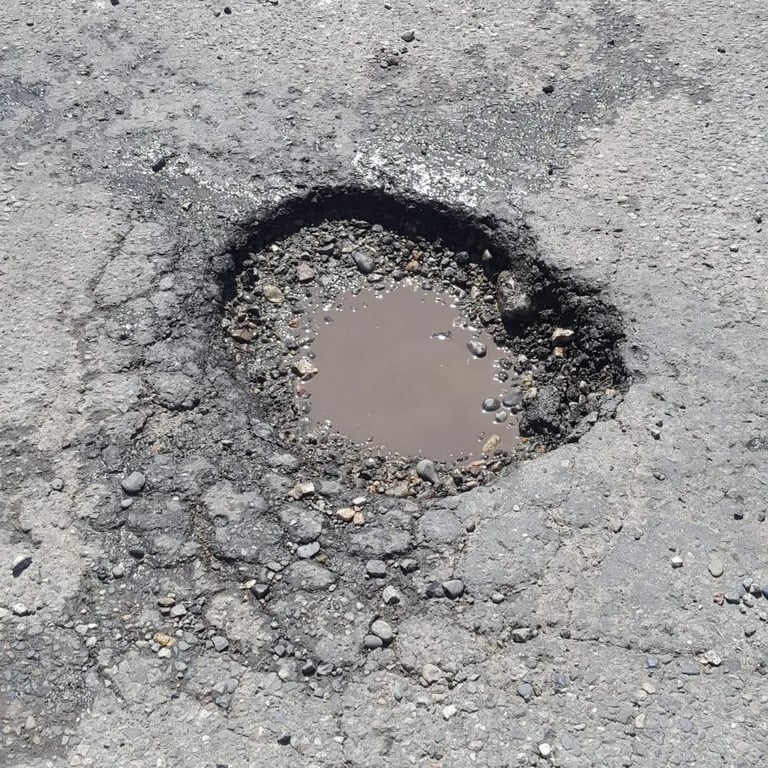 Pothole that needs repaired on parking lot job