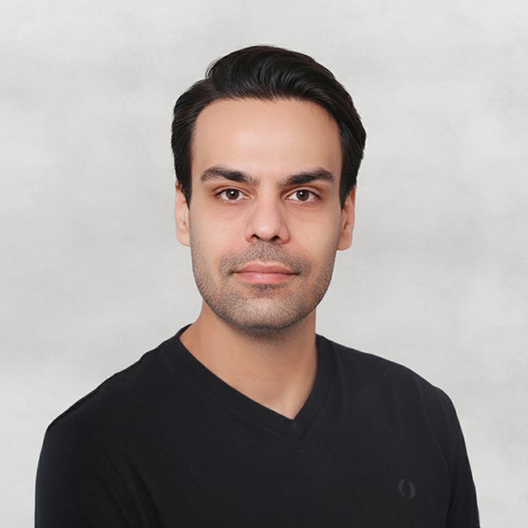 Portrait of a VISUALISE team member in a black shirt, neutral background, soft lighting, and centered composition.