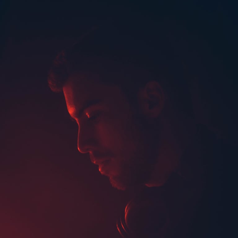 a man in a black shirt and red light