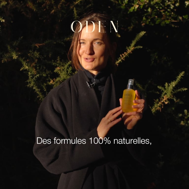 a woman in a black coat and a cosmetic bottle