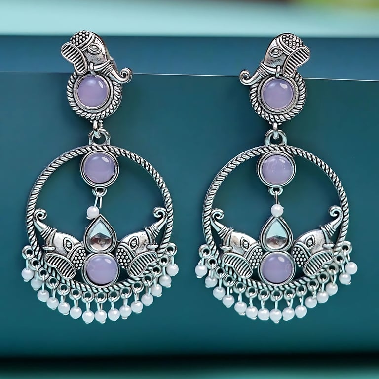 a pair of earrings with a purple and white flower