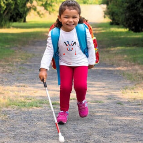 Child with strabismus walking with a O&M white cane for the legally blind and visually impaired with low vision    