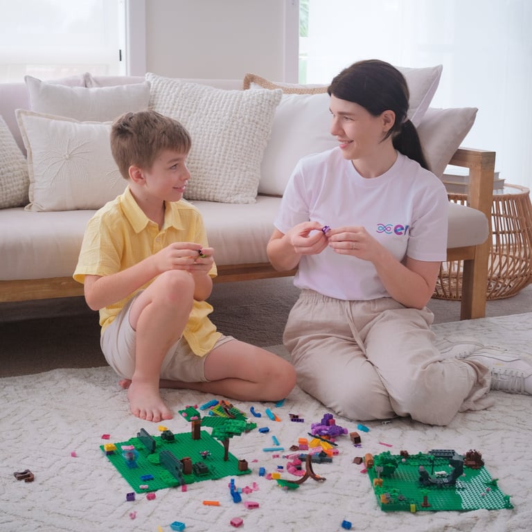 Image of a young boy and OT Frances playing with Lego