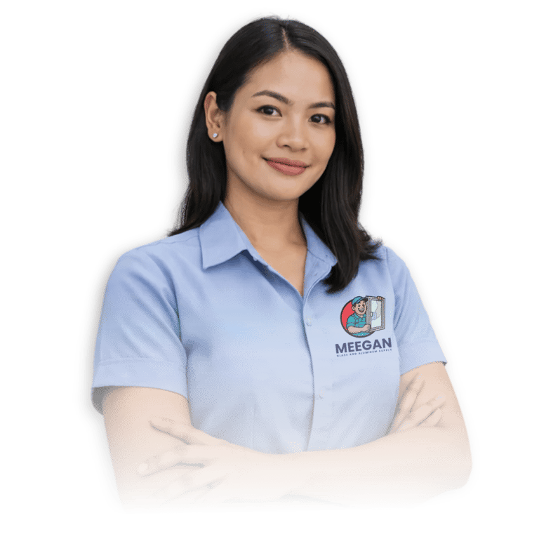 A woman wearing a blue shirt with a "Meegan Glass and Aluminum Supply" logo stands confidently with arms crossed