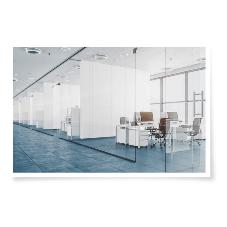 a large office with a glass wall partition and a computer desk