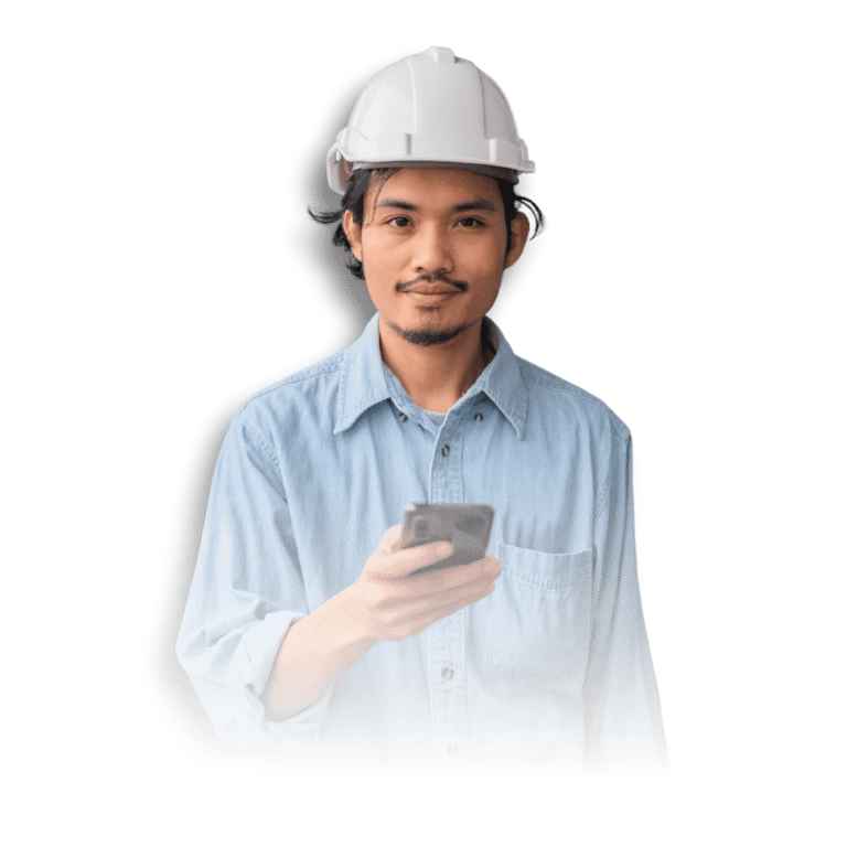 A person in a blue denim shirt and white hard hat holds a smartphone in front of a black background.