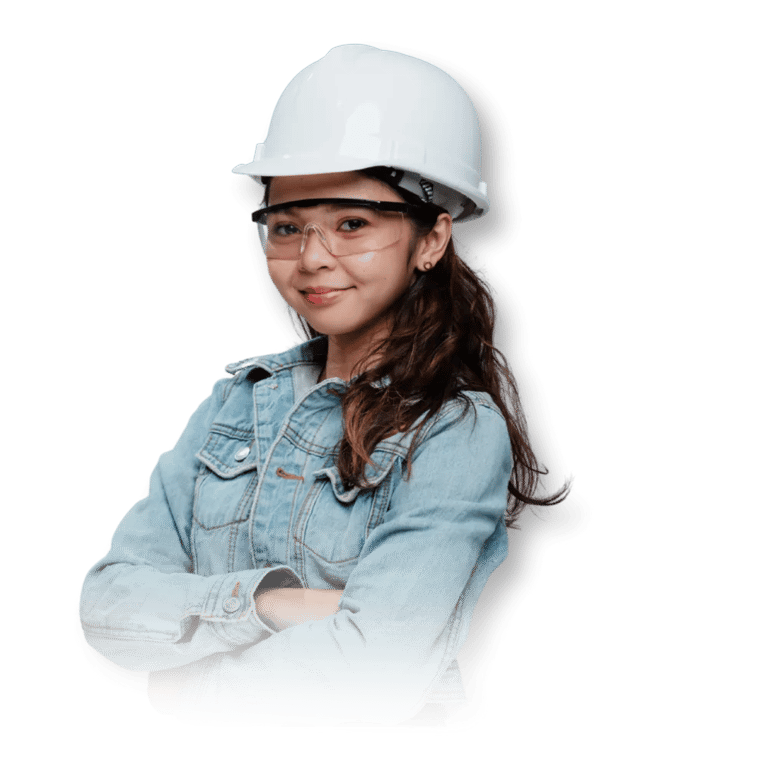 A woman wearing a white hard hat and denim jacket stands confidently with arms crossed against a black background.