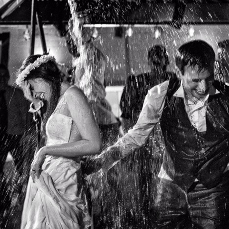 Bride and Groom having fun in the rain