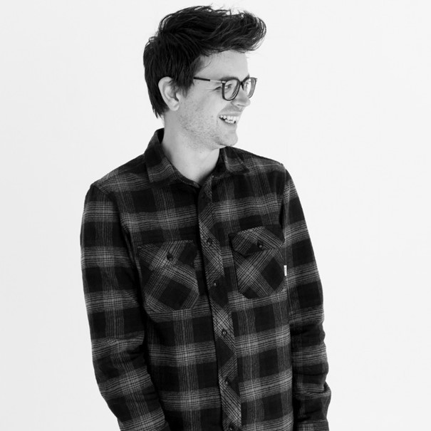 a man in a plaid shirt and glasses