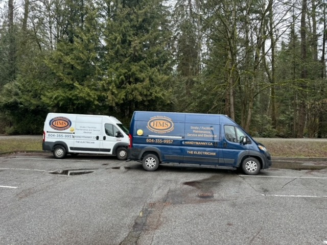 two renovation service vans parked in a parking lot