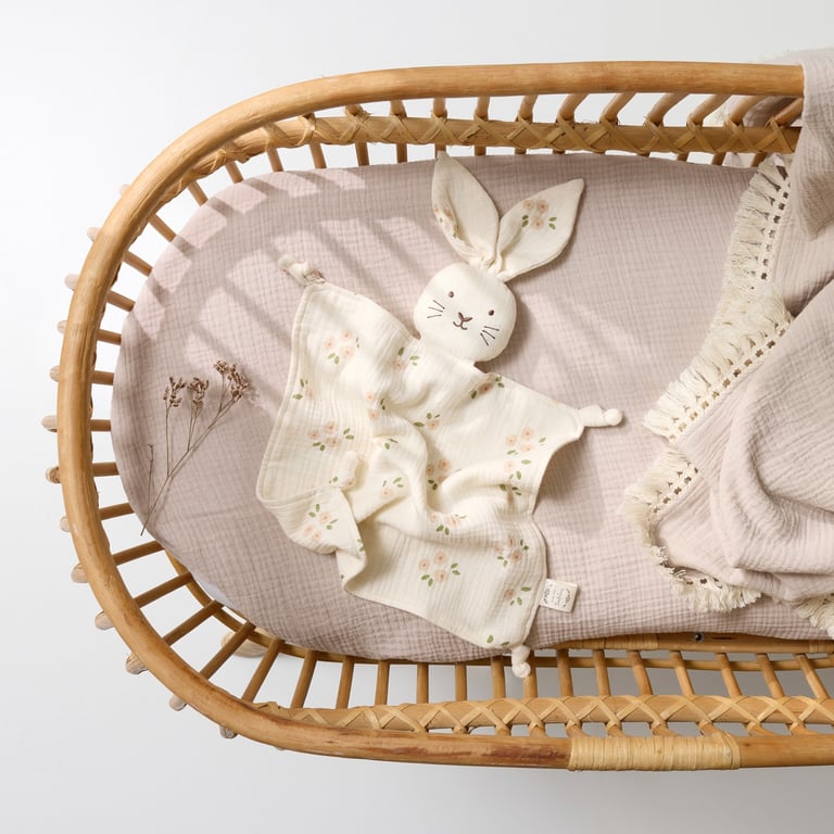 Product photography - a baby's cradler with a blanket and a bunny