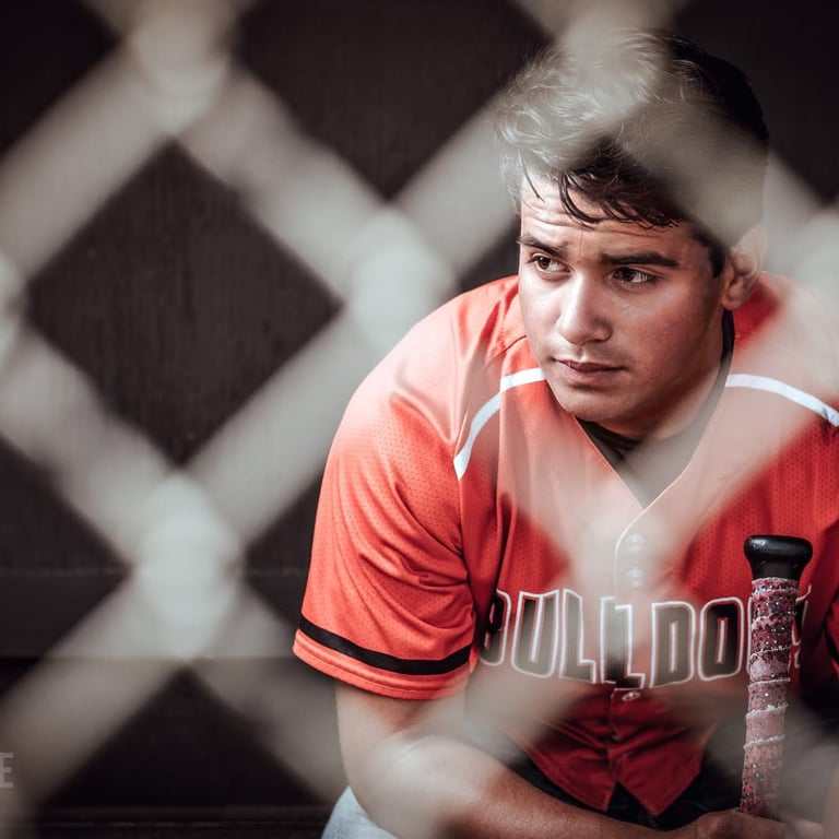 a baseball player is sitting in the dugout