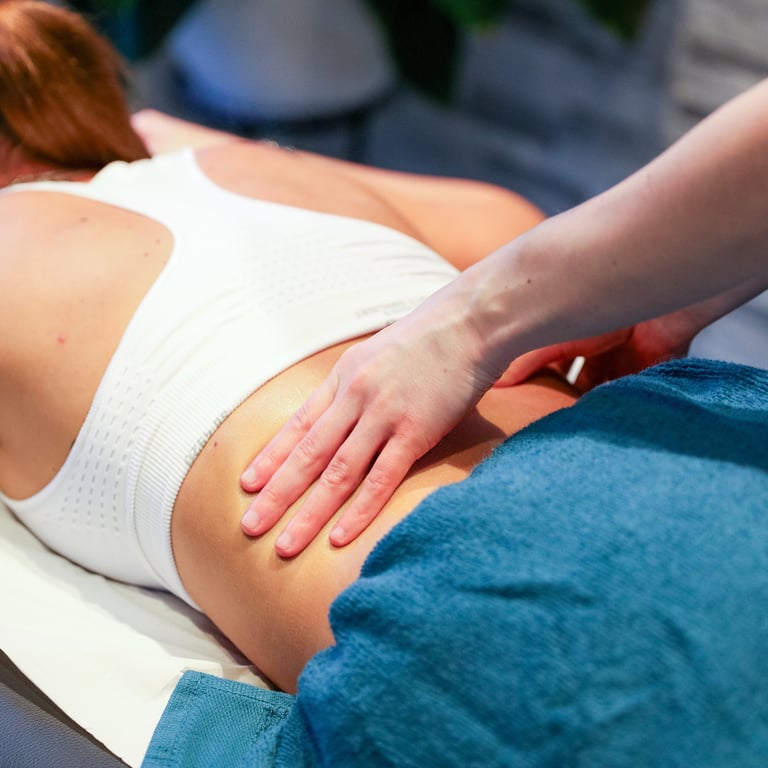 Sports Therapist providing a back massage to a client