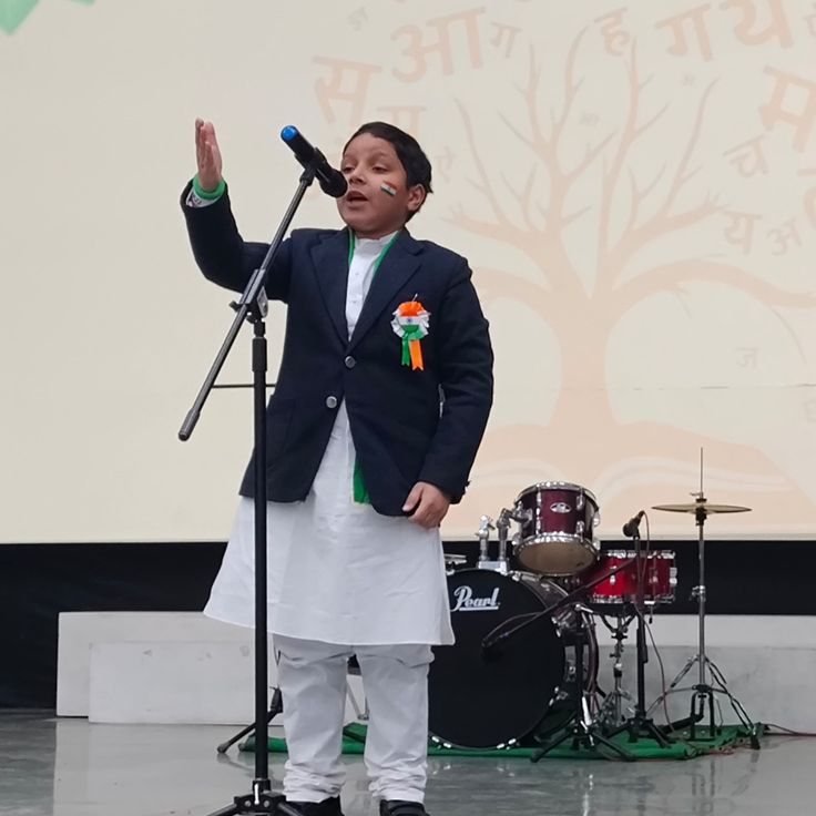 a man in a suit and tie is holding a microphone