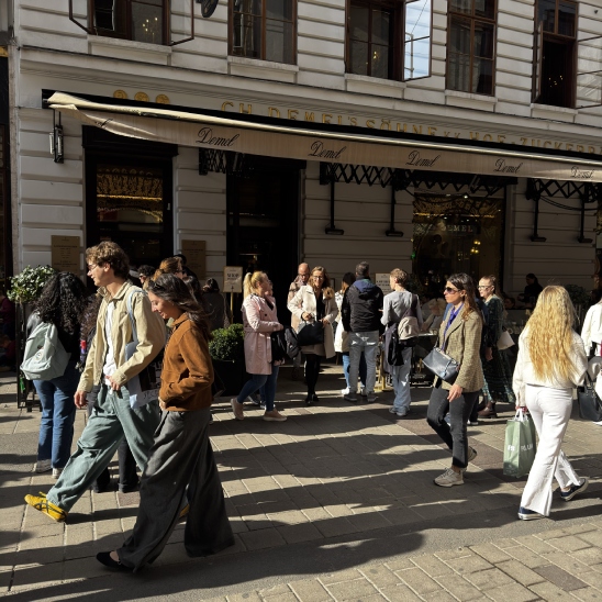 clientes en la entrada de la emblemática pastelería y cafetería Demel, bajo su clásico toldo beige