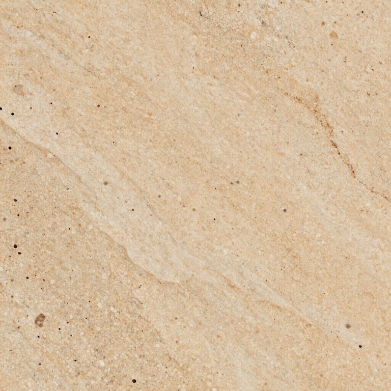 A detailed macro shot of a slab of warm-toned travertine showing its natural porous texture and elegant beige variations.