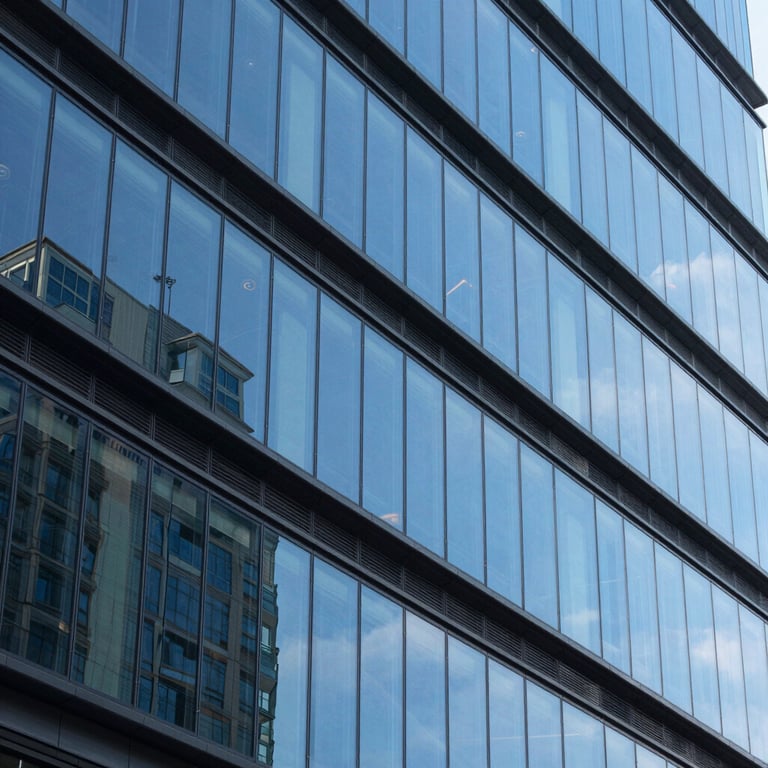 Abstract architectural lines of a contemporary tech headquarters, showcasing bright blue glass and dark gray steel.