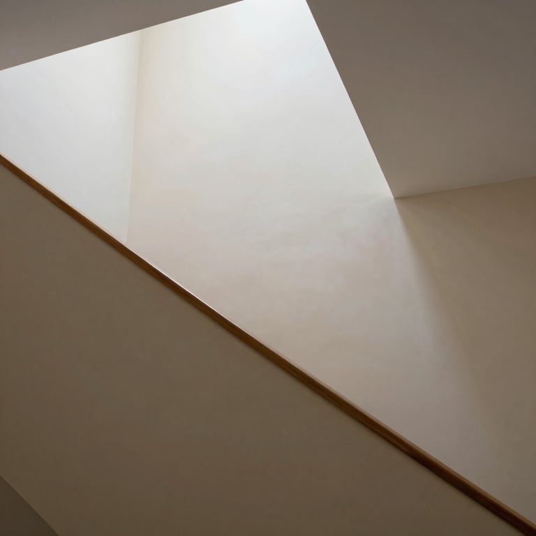 An impeccably painted stairwell with sharp lines between white ceilings and beige walls, showcasing precision.